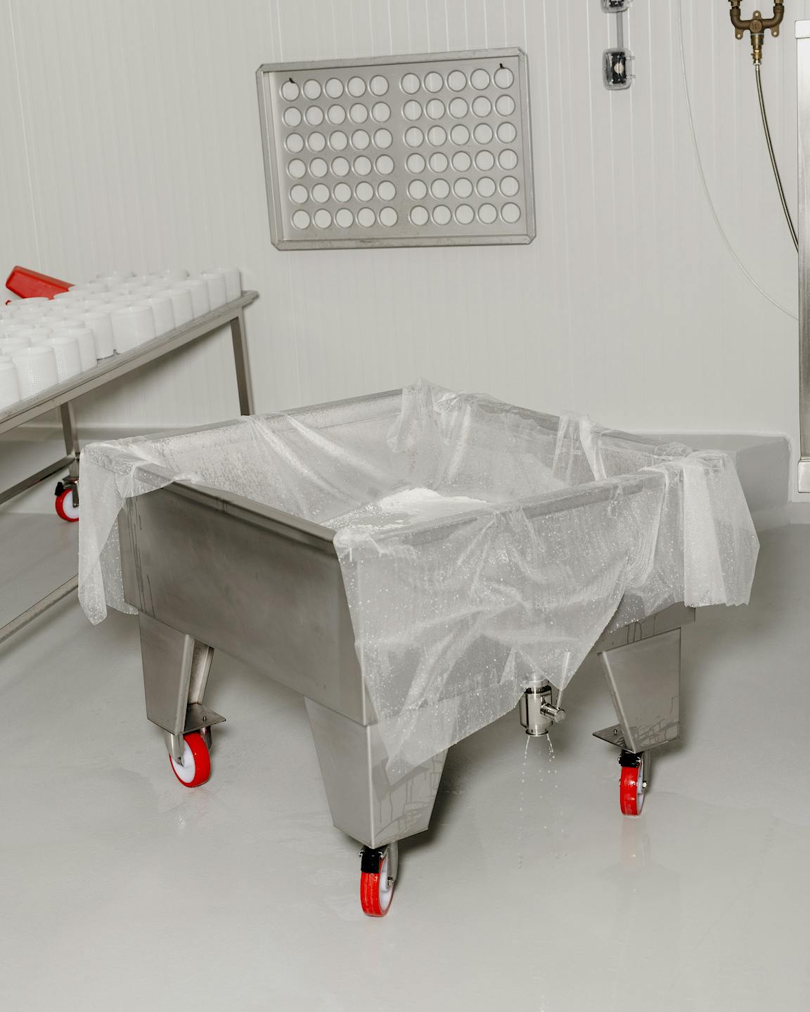 A large metal cart is covered with cloth.